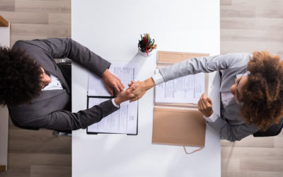 hiring manager shaking hands with candidate at job interview